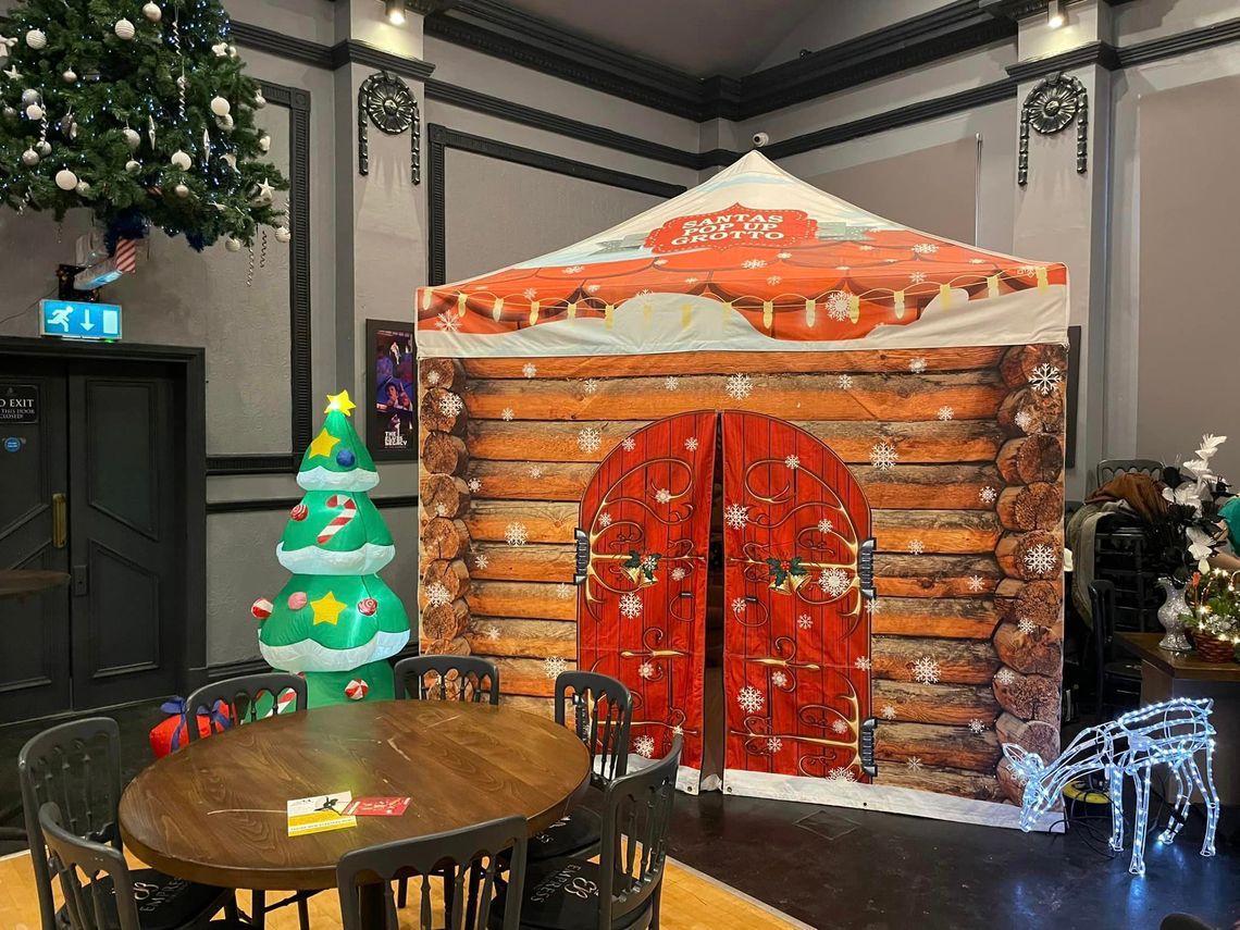 A printed pop up gazebo as a Santa's Grotto inside a venue