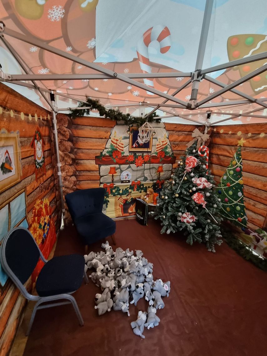 A santa's grotto, decorated with Christmas trees