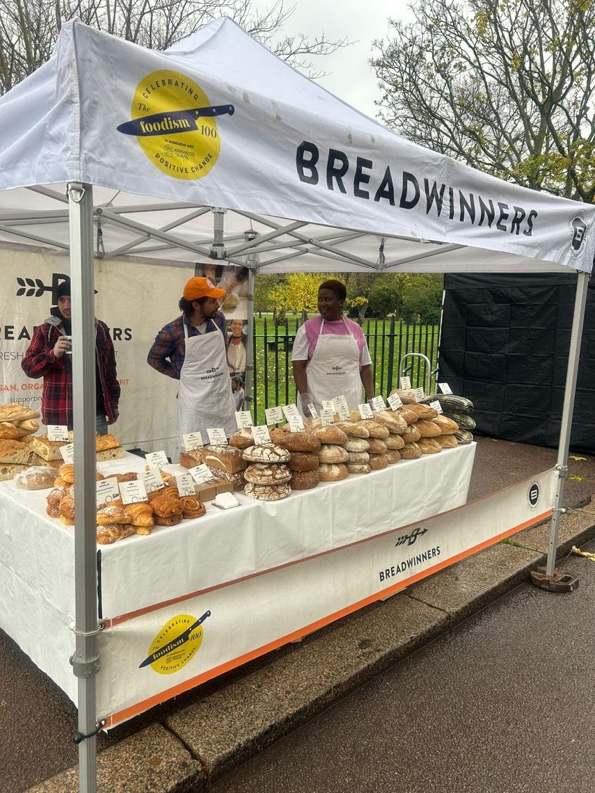 A white gazebo with a printed valance for a bakery