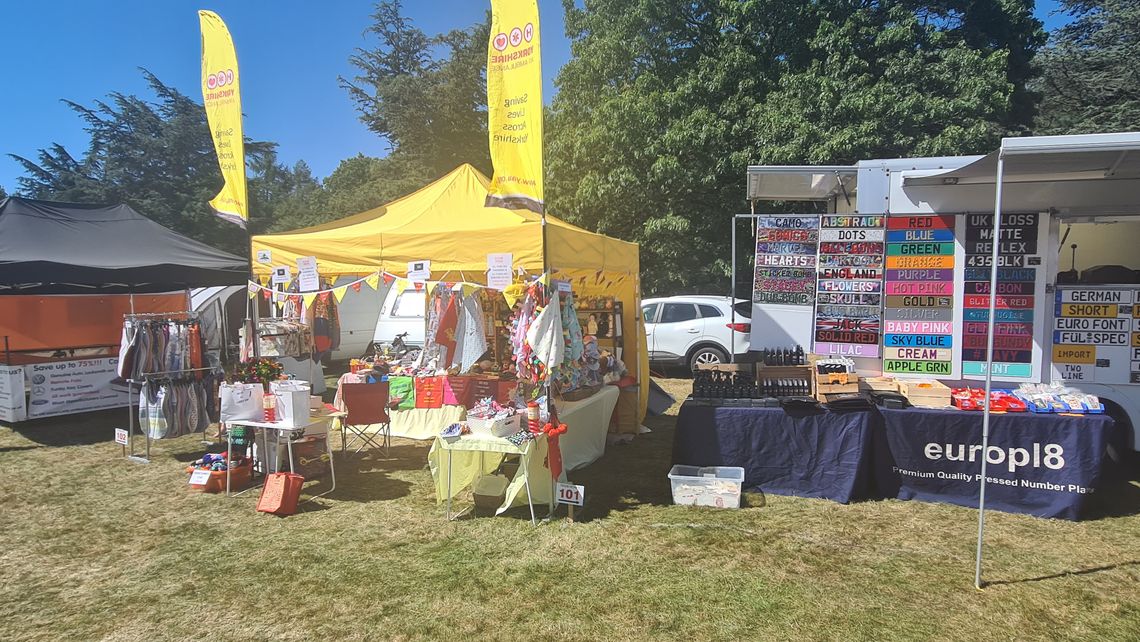 A yellow pop up gazebo at a festival