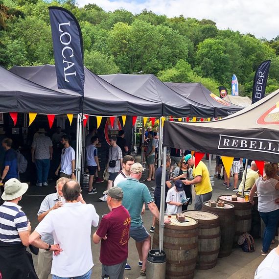 Custom printed flags displayed at an outdoor event, showcasing vibrant full-colour branding