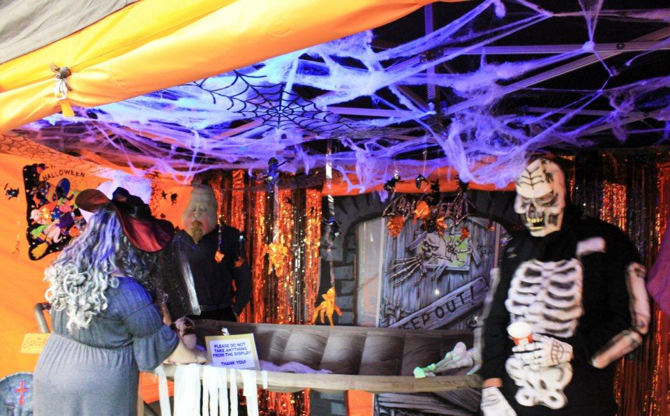 A photo taken from inside a Pop Up Gazebo decorated for halloween with guests in costume inside