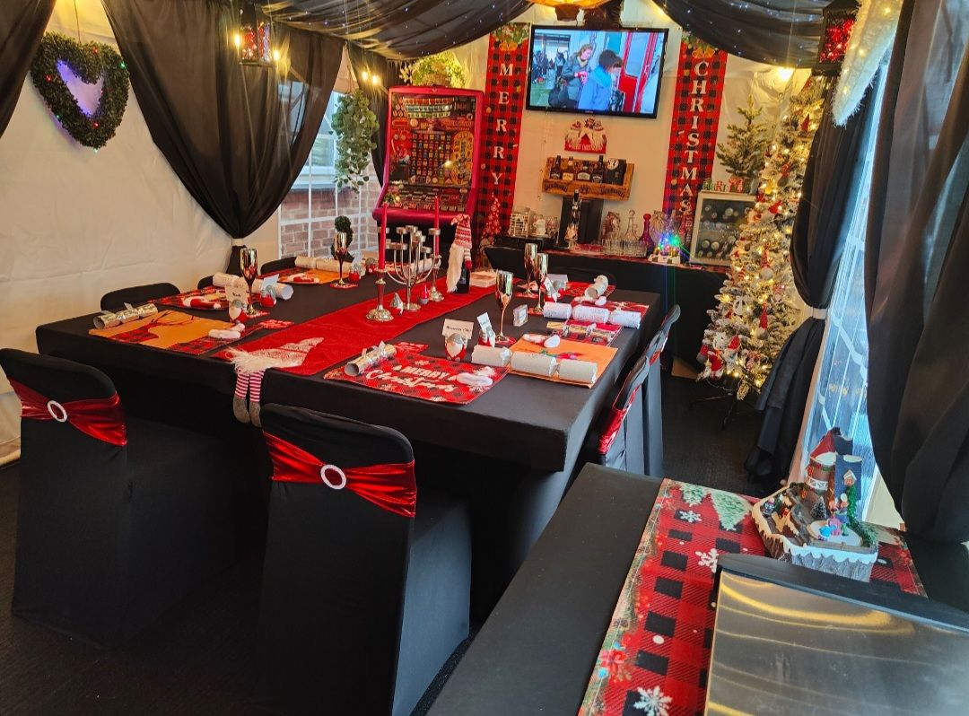 A christmas dinner scene, with a table set up for lunch inside a marquee