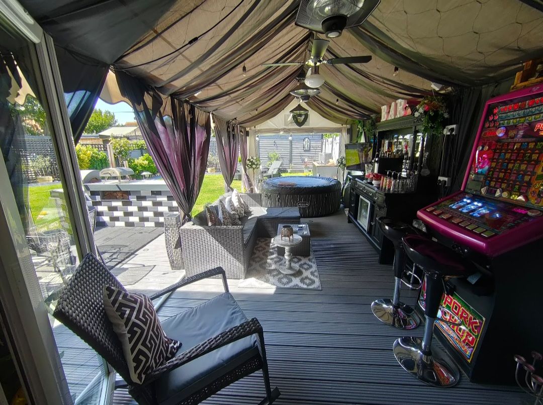 An internal view of a decorated garden marquee with lining and furniture