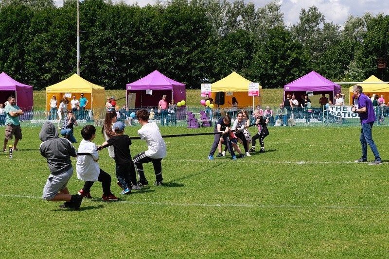 Children competing in tug o war on a school sports day