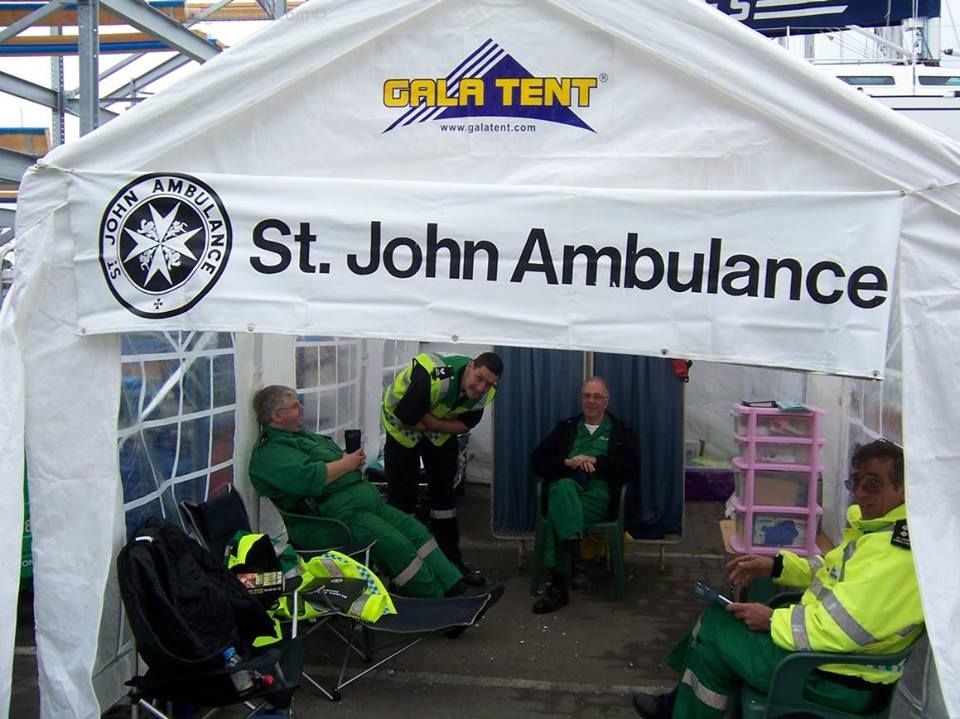 Printed St John Ambulance banner over a Gala Tent marquee