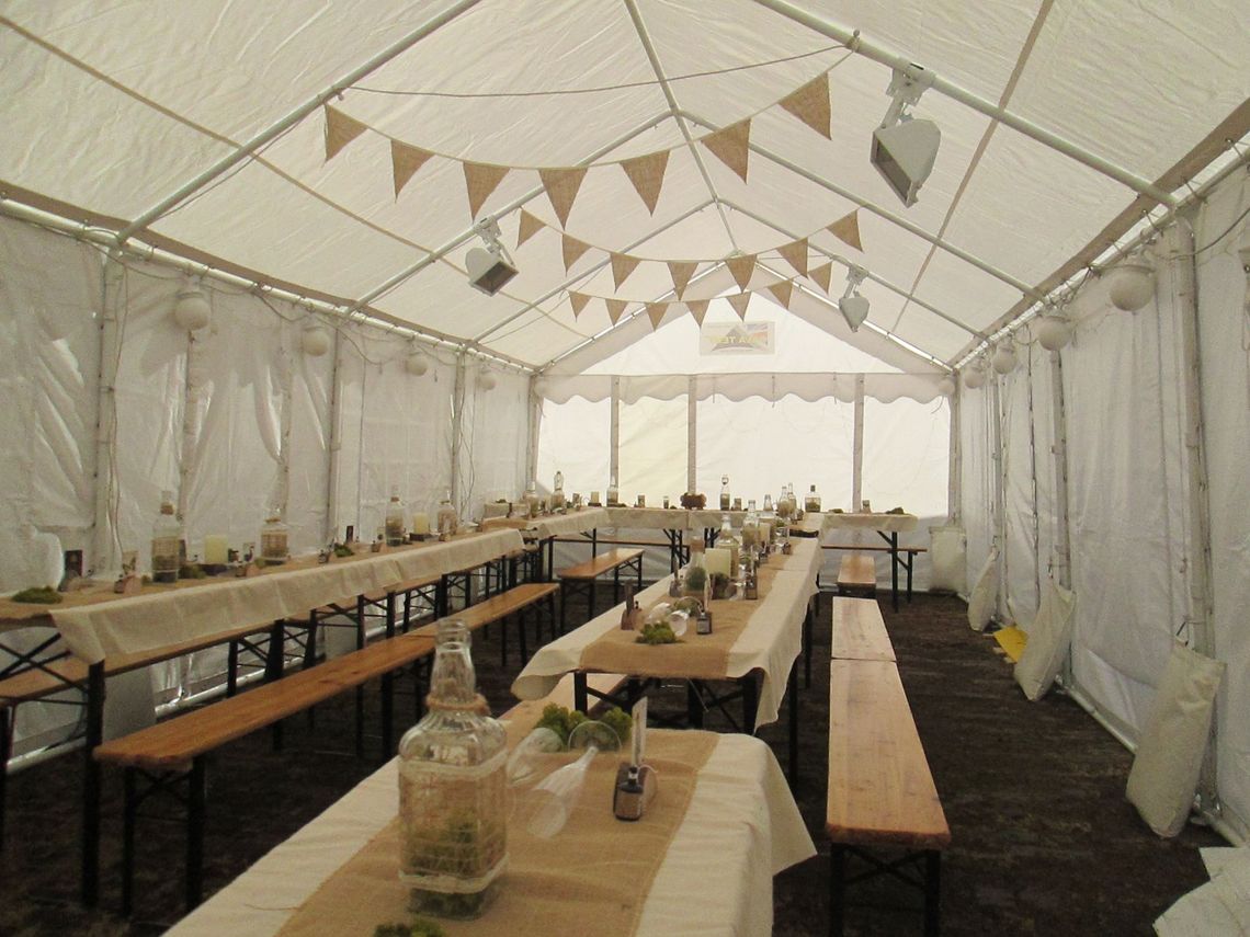 A gala tent marquee decorated for a wedding event