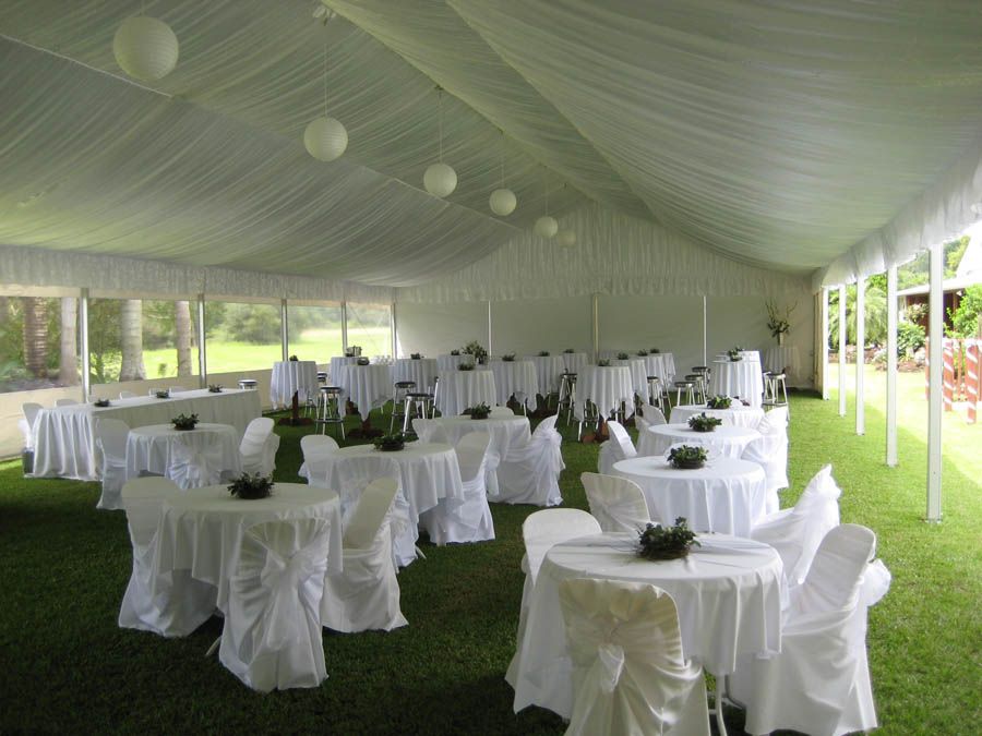 A gala tent marquee decorated for a wedding event