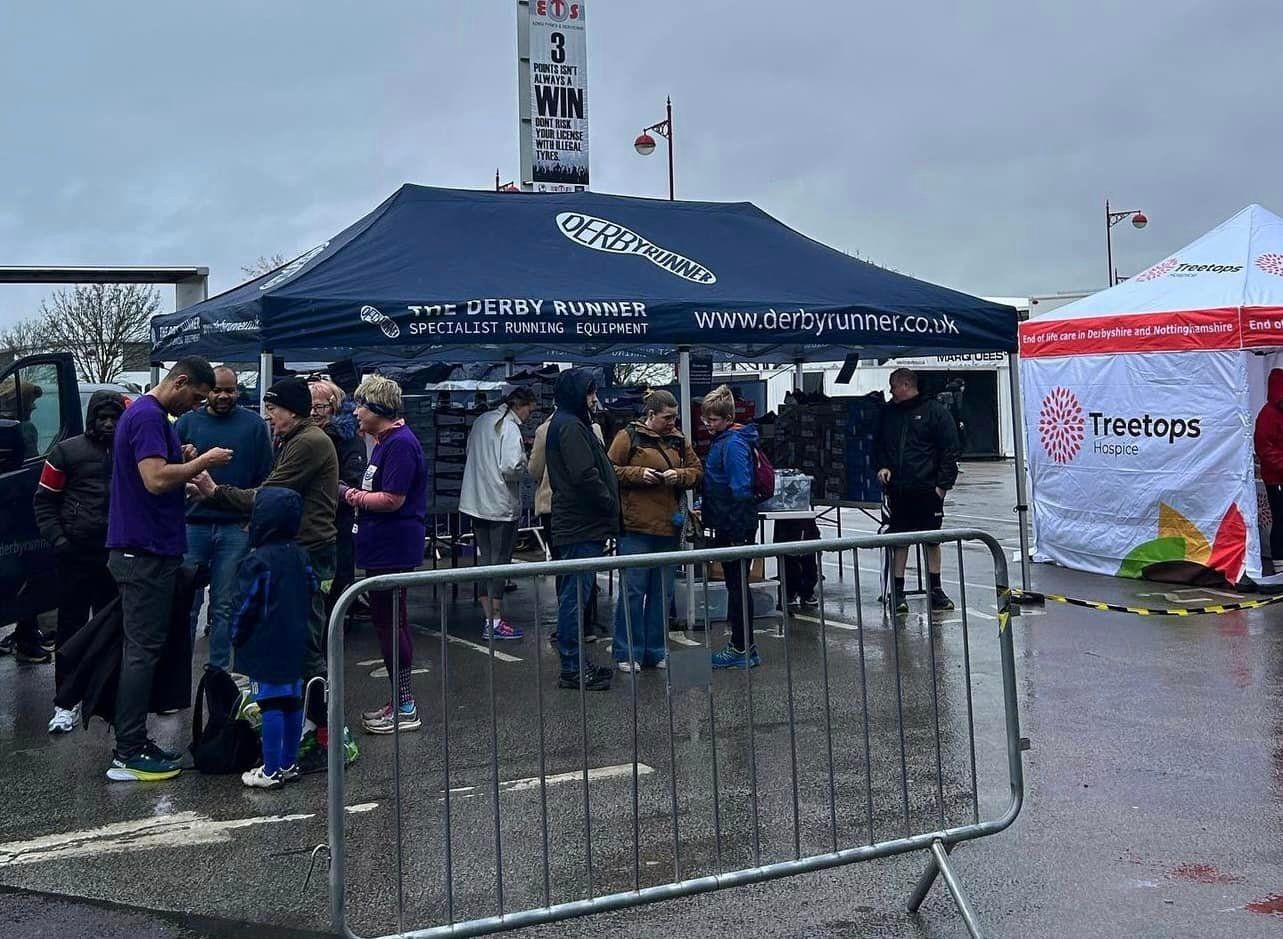 A printed waterproof gazebo providing shelter at a rainy outdoor event