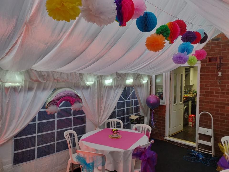 an interior view of a marquee decorated for a colourful birthday party