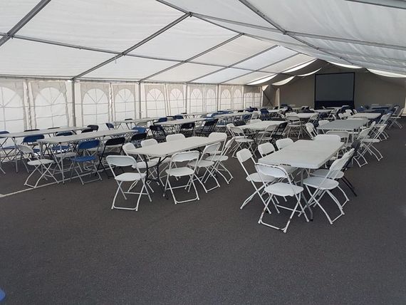 marquee for corporate event 3 A marquee for a large corporate event with tables and chairs set up