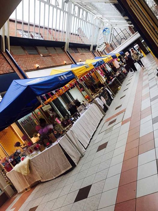 A row of indoor market stall marquees