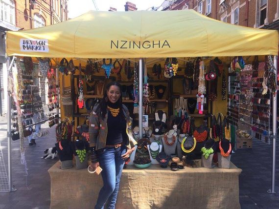 A yellow gazebo being used as a market stall selling jewellery