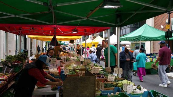 Green street market gazebo selling fruit and veg