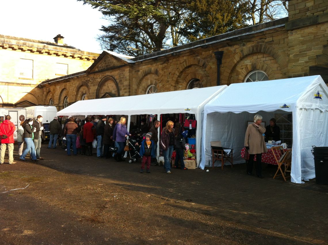 A row of commercial marquees being used as trade stalls