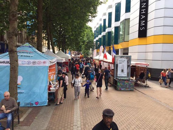 A street market with stalls using gazebos and branded gazebos as shelter