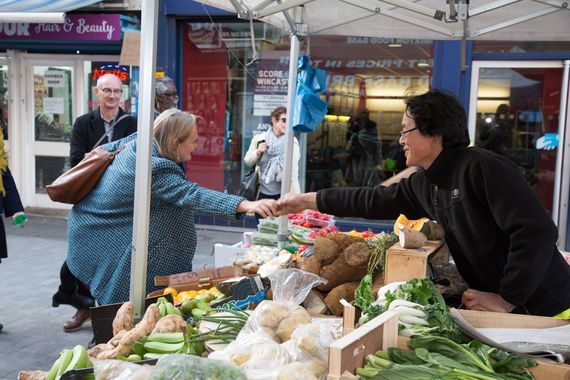 A pop-up gazebo used as shelter for a fruit and veg stall