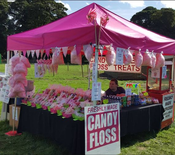 A pink gazebo market stall serving candy floss