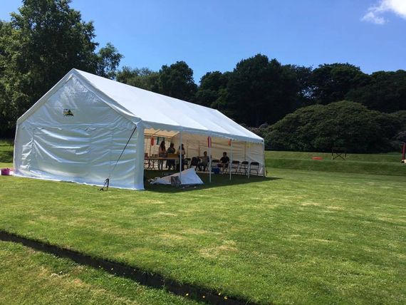 A large marquee at an outdoor summer event