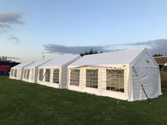 Four marquees in a row at a country fair