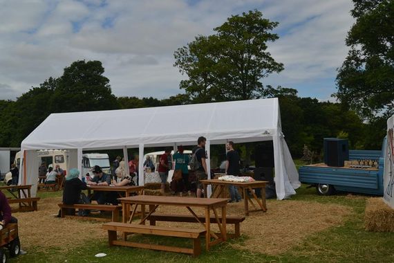 A marquee providing shelter at a summer festival