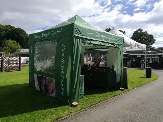 A green printed gazebo at an outdoor country show
