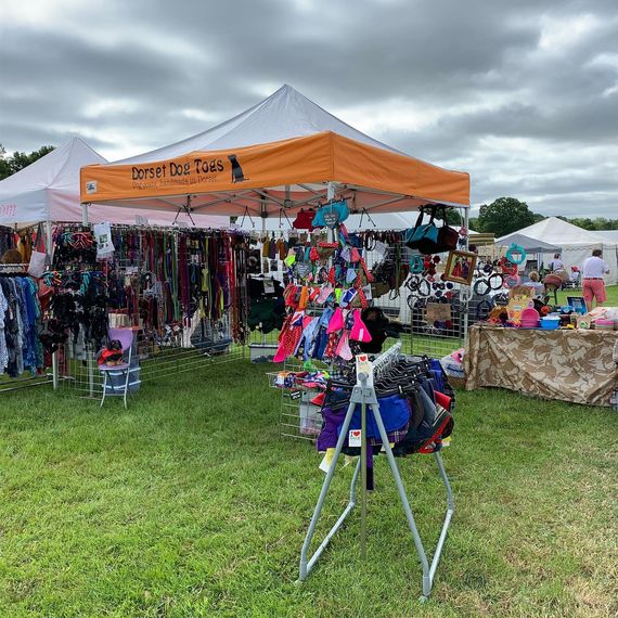 A white gazebo with printed valance at a country show