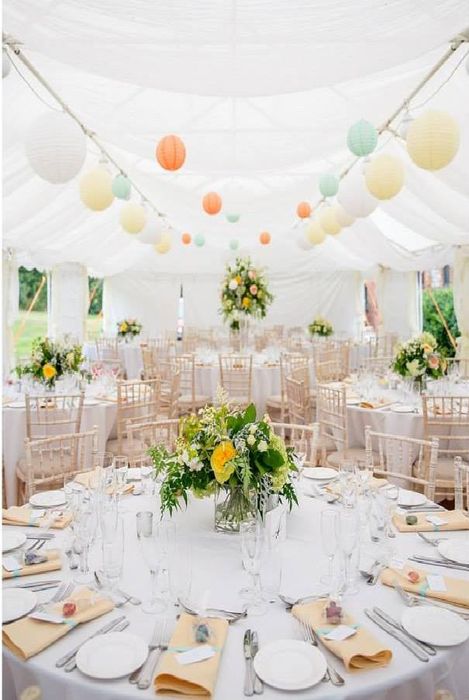 A Gala Tent Marquee decorated for an outdoor wedding with many tables and balloons