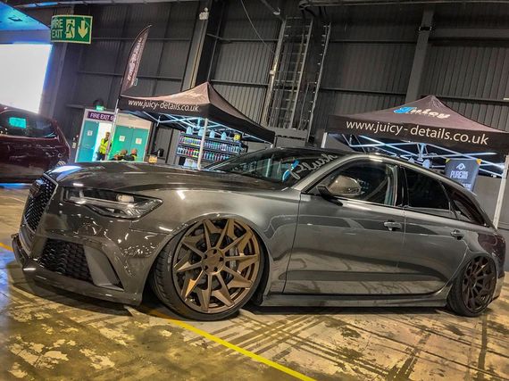 Car at a motorsport show with gazebos in the background