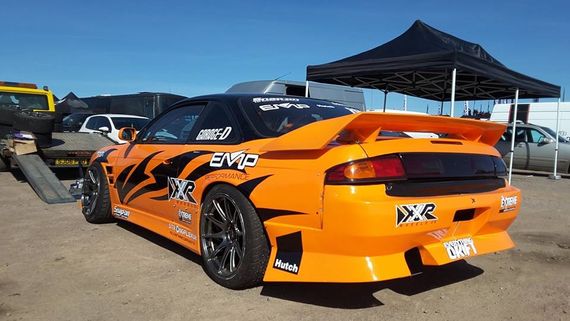 pop up motorsport tent 13 Black pop up gazebo in the background at a motorsport show with an orange and black car infront