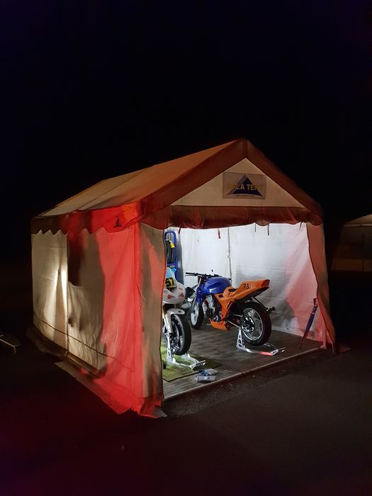marquee in motorsport bikes Gala Tent Marquee sheltering two motorsport bikes