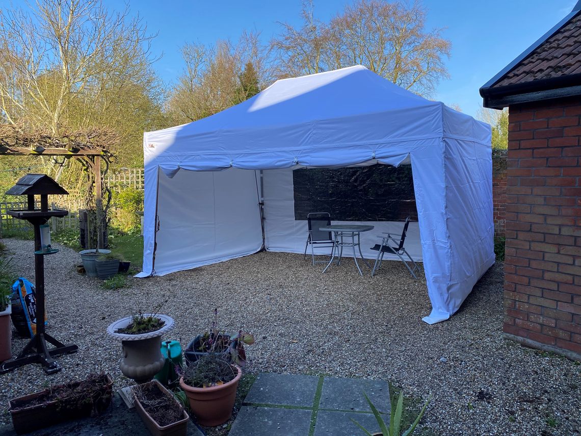 A white 3m x 4.5m Gala Shade Gazebo in white in someone's garden