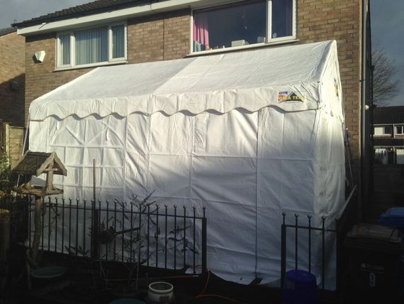 A gala Tent Marquee with sides in a small residential lot