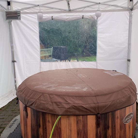 A gala shade gazebo covering a hot tub in the garden