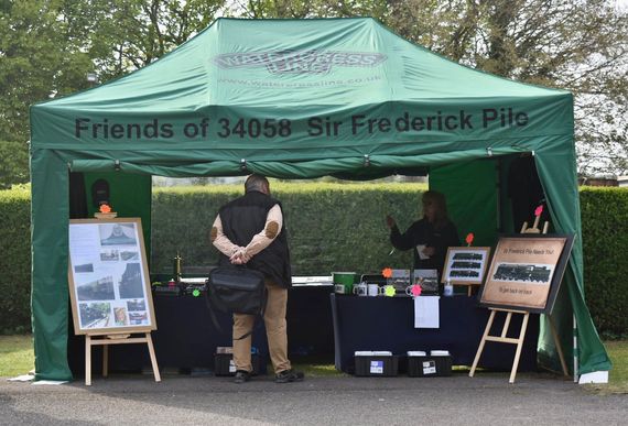 printed green instant awning A printed gazebo with a company logo at an outdoor event