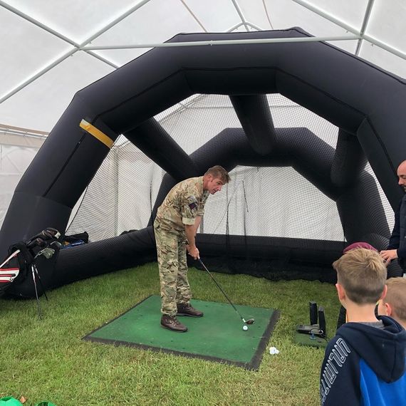 A pop-up mini golf event set up inside a large Gala Tent marquee
