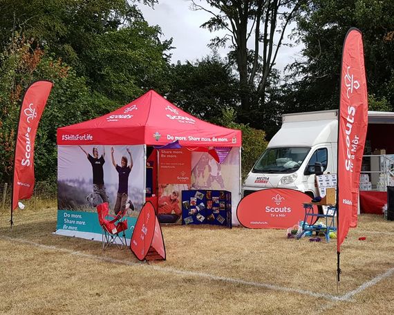 red printed scouting gazebo A Gala Shade printed gazebo at an outdoor scouting event with matching printed feather flags