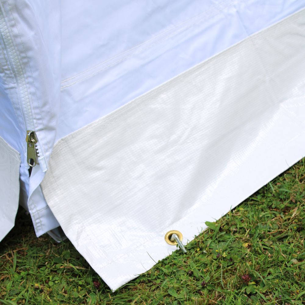 A close up of a Gala Shade Gazebo sidewall pegged to the ground