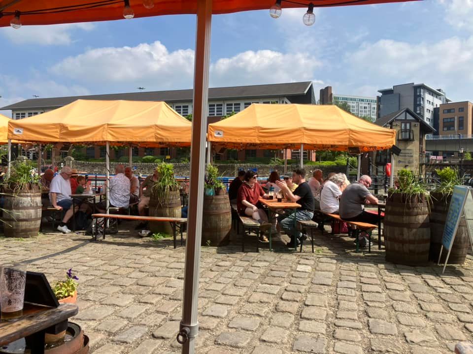 Orange gazebos covering patron outside the Dorothy Pax in Sheffield