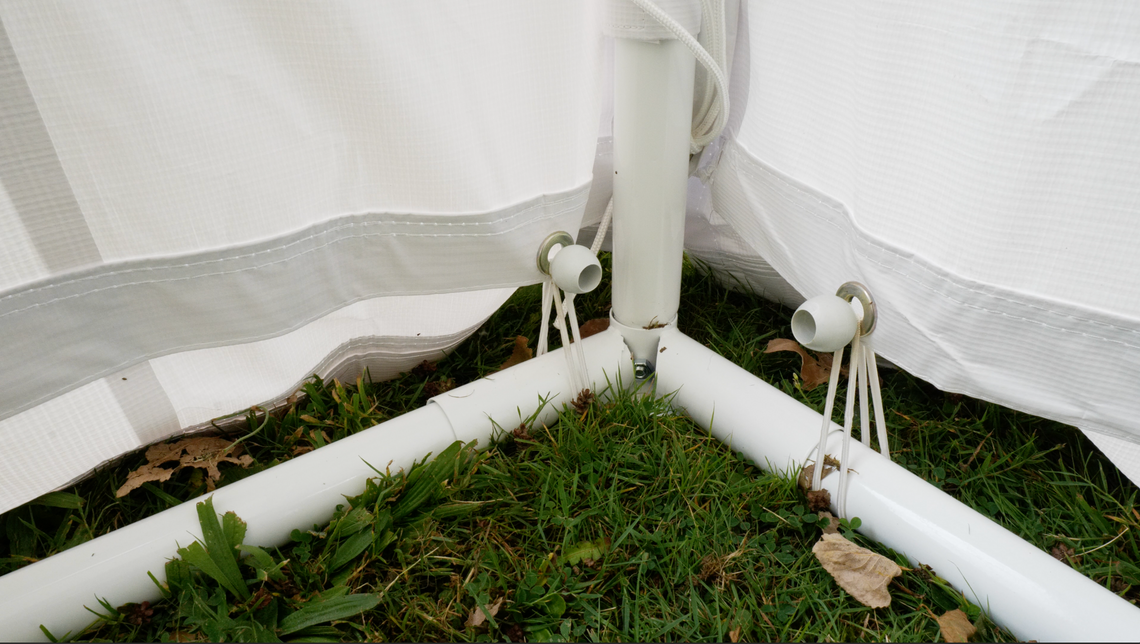 a close up view of marquee groundbars meeting at the corner pole