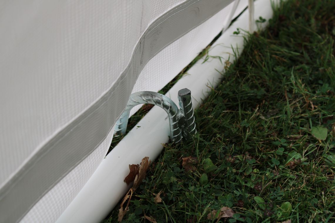 close up view of marquee ground bars and a ground anchoring peg