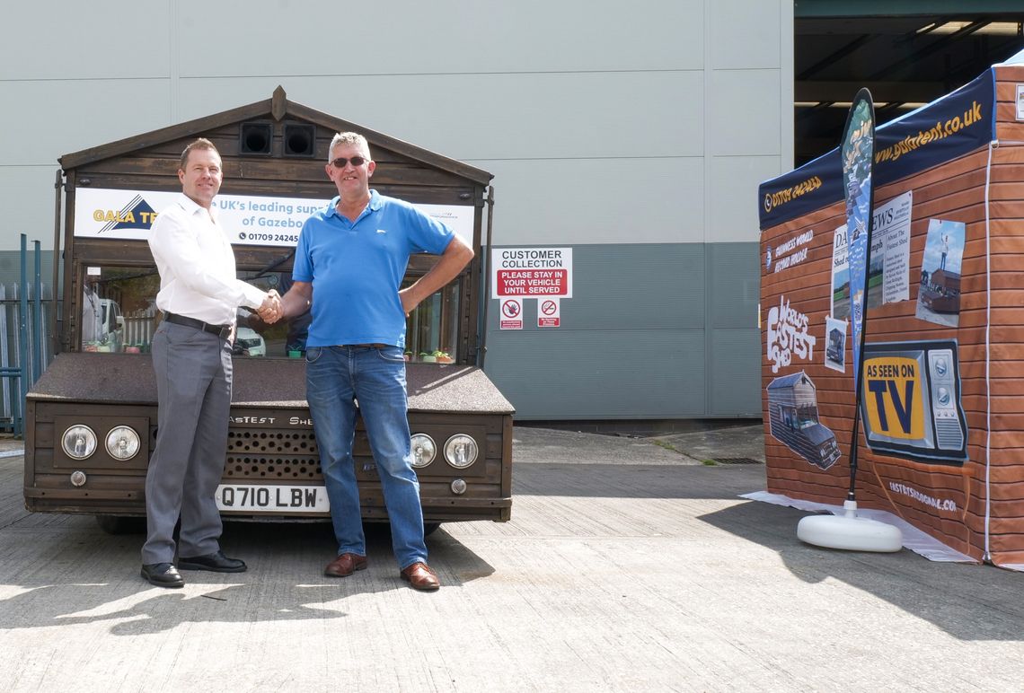 Kevin Nicks and Jason Mace standing infront of The World's Fastest Shed and the Driveable Gazebo
