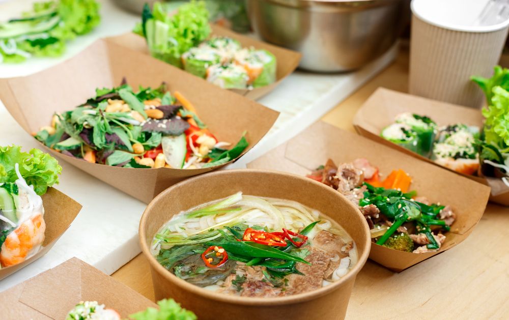 A selection of cartons with street food in them