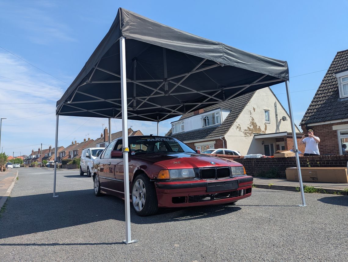 bmw beneath black gazebo