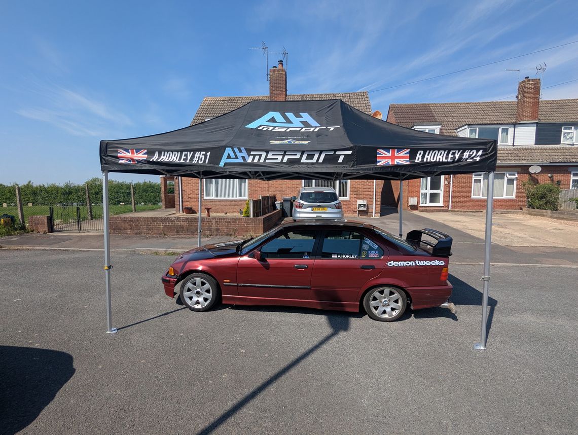 red bmw under black gazebo